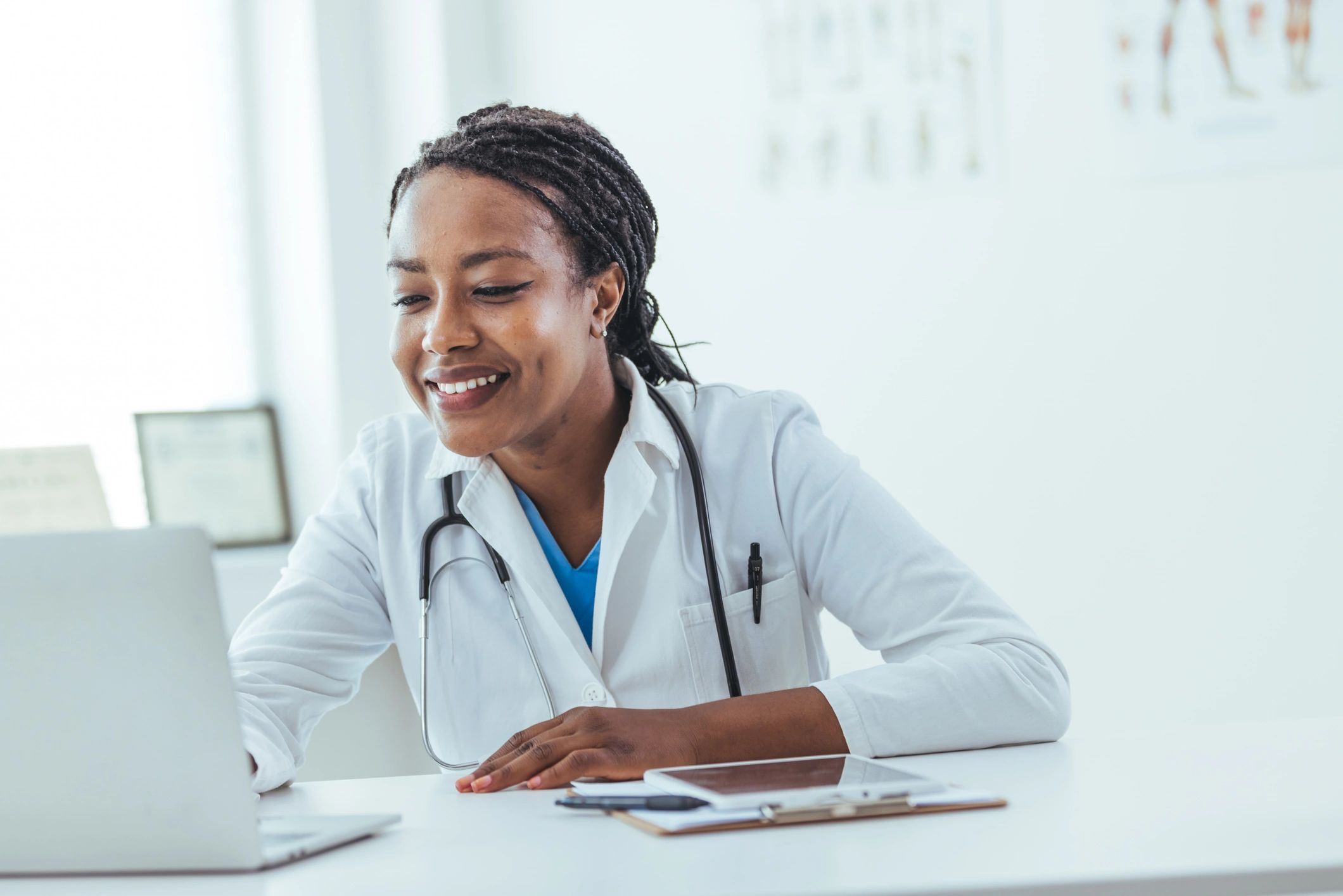 Doctor working on a laptop in a clinic setting