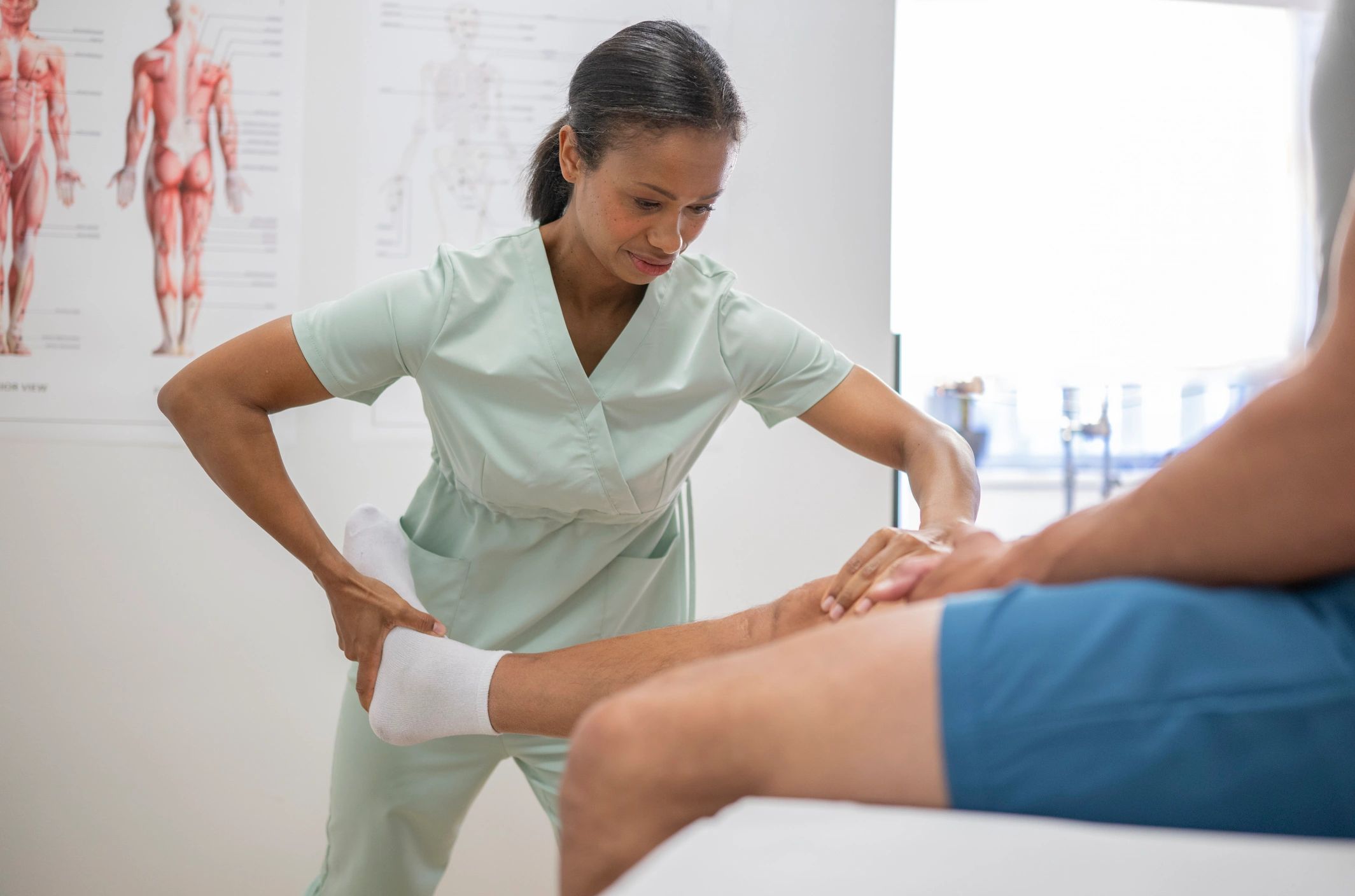 Physical therapist assisting a patient during a session